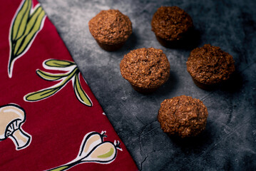 Homemade cupcakes on granite with red napkin