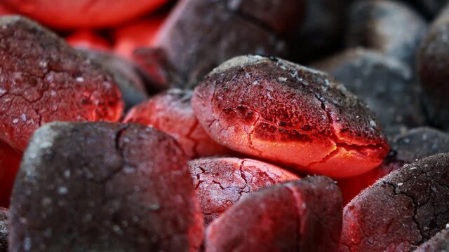 Glowing Charcoal Briquettes, BBQ oder close up of coals burning
