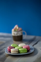 Plate of colored macaroons and a cup