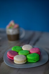 Plate of colored macaroons and a cup