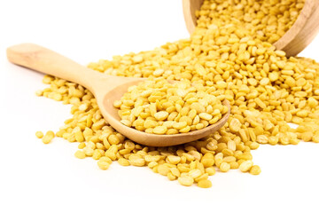 peeled split mung bean in wooden scoop isolated on white background.Ingredients for cooking Healthy and Natural Food concept