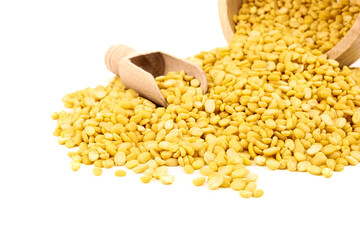 peeled split mung bean in wooden scoop isolated on white background.Ingredients for cooking Healthy and Natural Food concept