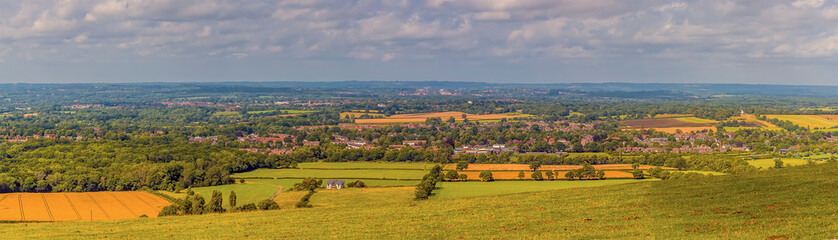 Fototapeta na wymiar A panorama view from the top of the South down across the Weald near Brighton, UK in summertime