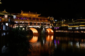 Night lights andtraditional bridge in the city of fenghuang, China