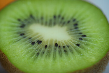 Naklejka na ściany i meble Macro photo of a fresh sliced kiwi