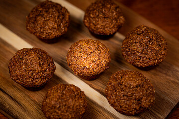 Healthy homemade bran muffins on wood serving tray