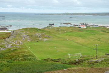 A Football Pitch looking out over stunning views of the nearby islands on the Isle of Eriskay, located in the Outer Hebrides off Scotland’s west coast © Nigar