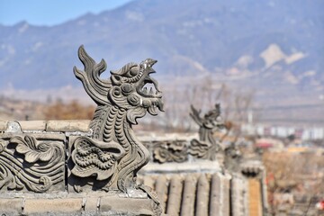 Stone dragon on the rooftop of traditional chinese house in Henan, China