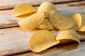 Plain Potato Chips (Crisps) on old shabby wooden table.