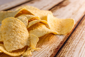 Plain Potato Chips (Crisps) on old shabby wooden table.