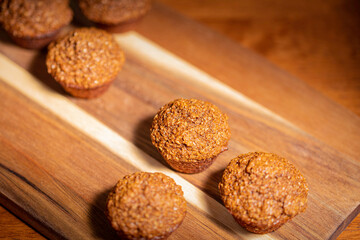 Healthy homemade bran muffins on wood serving tray