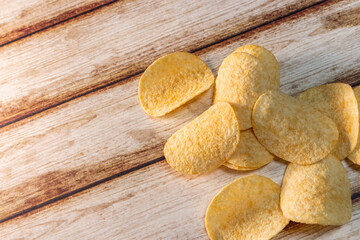 Plain Potato Chips (Crisps) on old shabby wooden table.