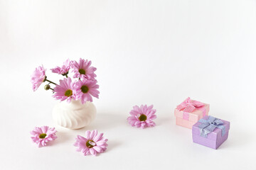Obraz na płótnie Canvas Romantic lovely bouquet of fresh pink chrysanthemums. Gift boxes on white background. Congratulations on Valentine's Day, Birthday or March 8th. Empty space for text. Close-up, copy space, mock up