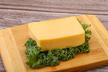 Tasty yelloow Tilsiter cheese brick