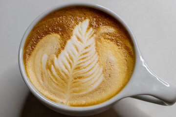 cup of coffee latte art with window light