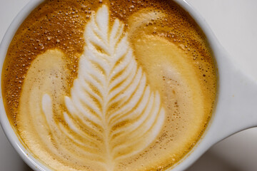 cup of coffee latte art with window light