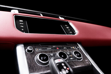 Red luxury modern car Interior. Steering wheel, shift lever and dashboard. Detail of modern car...