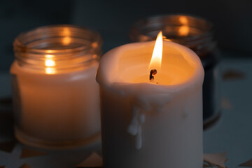 Candles. Home interior decoration. Romantic candles. White and black wax. In glass jars. Romantic...