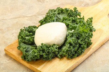 Soft mozzarella cheese over board