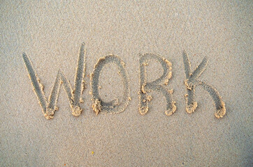 Work word on beach sand. Work phrase is written on a sand. Top view