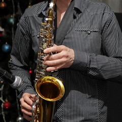 One European saxophonist close up with Golden saxophone, jazz music on celebration, musician work