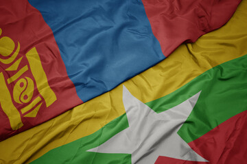 waving colorful flag of myanmar and national flag of mongolia.