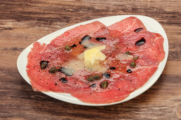 Carpaccio with capers, oil and parmesan