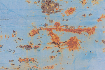 Blue rusted metal background. A rusty and scratched painted metal wall. Rusty metal background with streaks of rust .