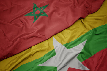 waving colorful flag of myanmar and national flag of morocco.