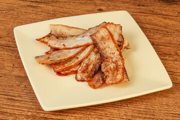 Roasted juicy bacon in the plate