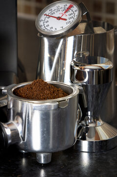espresso coffee maker in a kitchen setting with coffee utensils and fresh ground coffee