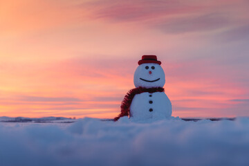 Funny snowman in stylish red hat and red scalf on snowy field during sunset. Merry Christmass and...