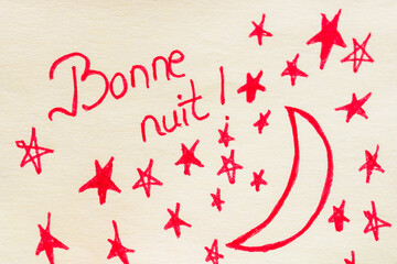 Bonne nuit (good night) handwriting text close up isolated on yellow paper with copy space.