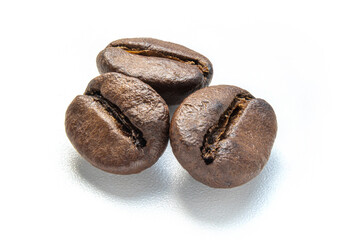 Closeup dark brown coffee beans isolated on white background. Top view. Flat lay. Macro