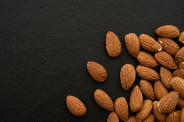 almond on black background. Top view. Flat lay (selective focus; close-up shot)