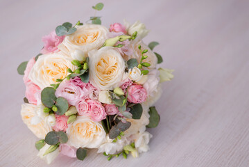 close-up of a beautiful bouquet on a gray background. Soft pink roses and cream, yellow