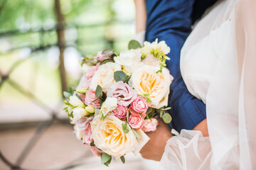 Obraz na płótnie Canvas bride and groom holding beautiful wedding bouquet of flowers