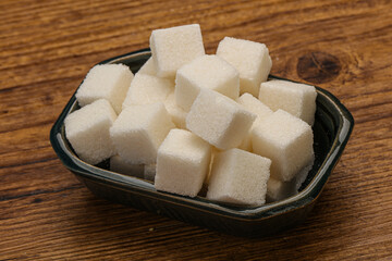 Refined white sugar cubs in the bowl