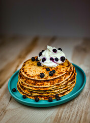 stack of pancakes with syrup and berries