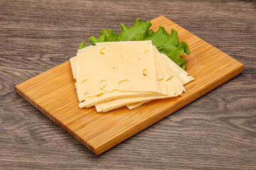 Sliced yellow cheese over board