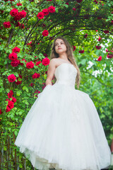 Obraz na płótnie Canvas Dreamy girl ballroom dress in rose garden, rosarium concept