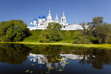 View of the Holy Bogolyubsky orthodox convent on the high bank and its reflection in the Klyazma river. Bogolyubovo, Vladimir region, Russia