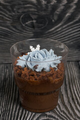 Biscuit trifles with chocolate and cream cheese. Decorated with mastic snowflakes. On pine boards.