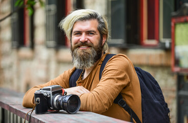 Old technology. Bearded man hipster take photo. Brutal stylish man with retro camera. Modern...