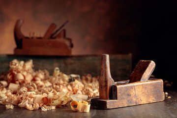 Old wooden jointers and shaving on wooden table.