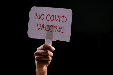 Hands Holding No covid vaccine board - concept covid-19 coronavirus vaccination protest, anti...