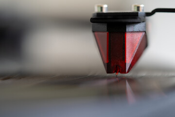 Close-up of turntable pick-up and needle playing a vinyl record