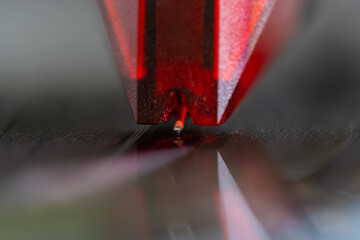 Close-up of turntable pick-up and needle playing a vinyl record