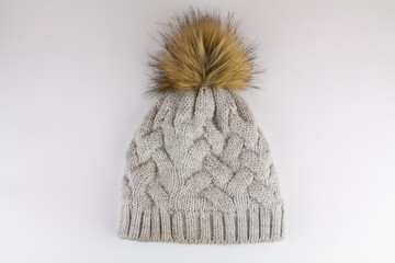 beautiful knitted winter hat on a white background