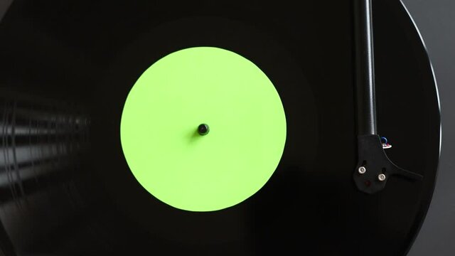 Turntable playing vinyl LP record top view. Party, leisure, music, hobby, enjoying life, having fun, technology concept.